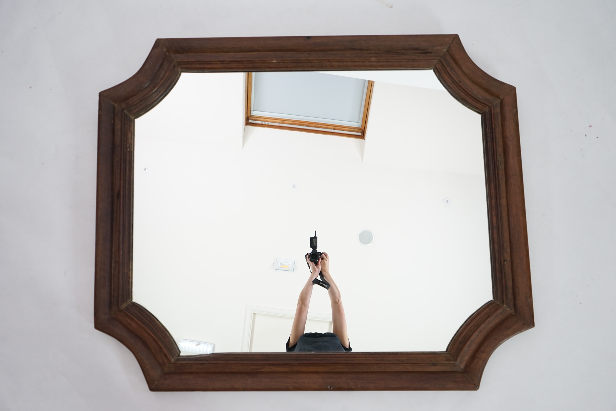 An antique French walnut wall mirror